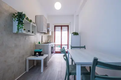 a kitchen and dining room with a table and chairs at Garden House by BuddyRent in Rome