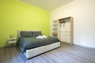 a bedroom with a bed and a green wall at Garden House by BuddyRent in Rome