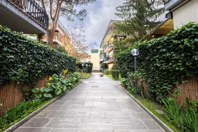 a walkway between two buildings with plants at Garden House by BuddyRent in Rome