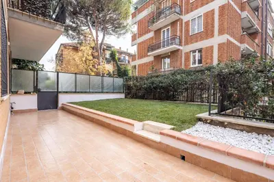 an empty courtyard of a building with a yard at Garden House by BuddyRent in Rome