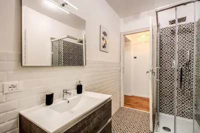a bathroom with a sink and a shower at MONTI QUIET AND SPACIOUS APARTMENT in Rome