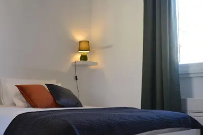 a bedroom with a bed with a lamp and a window at Maison Coco' in Rome in Rome