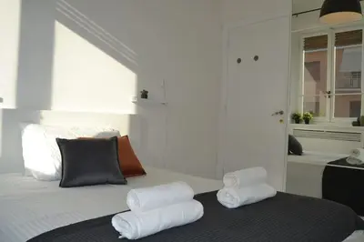 a bedroom with a bed with three pillows on it at Maison Coco' in Rome in Rome