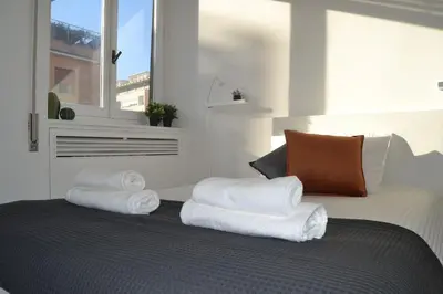 a pile of towels sitting on top of a bed at Maison Coco' in Rome in Rome