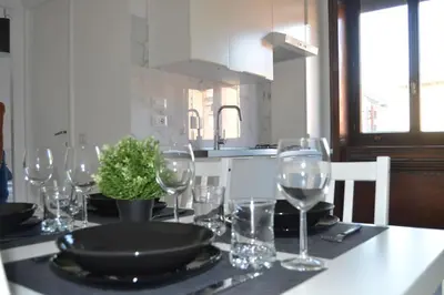 a table with wine glasses and a plate on it at Maison Coco' in Rome in Rome