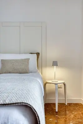 a bedroom with a bed and a side table at Charme Apartment In Balduina by RHR in Rome