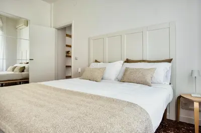 a bedroom with a large white bed with two pillows at Charme Apartment In Balduina by RHR in Rome