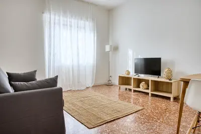 a living room with a couch and a television at Charme Apartment In Balduina by RHR in Rome