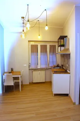a kitchen and dining room with a table and a kitchen and a dining room at Monolocale Urban House Marconi in Rome