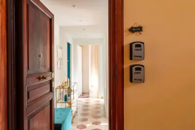 a room with a door and a hallway with a tile floor at G & G Maisonette Testaccio in Rome