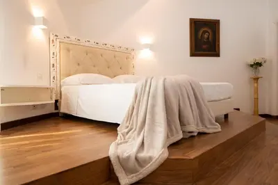 a bedroom with a bed with a blanket on it at ART ATELIER VITELLESCHI in Rome