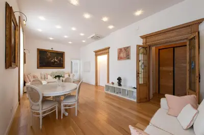 a living room with a table and chairs at ART ATELIER VITELLESCHI in Rome