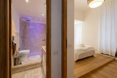 a bathroom with a bed and a shower in a room at ART ATELIER VITELLESCHI in Rome