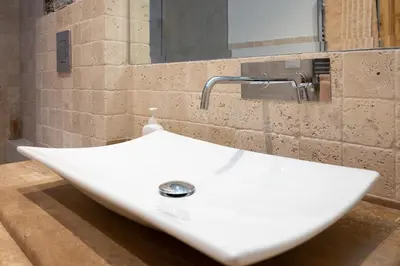 a white sink in a bathroom with a mirror at ART ATELIER VITELLESCHI in Rome