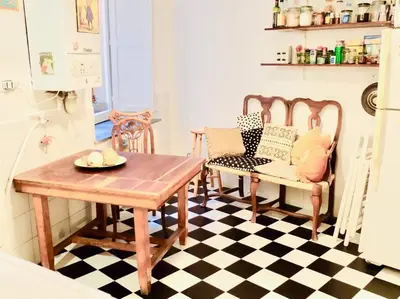 a kitchen with a table and two chairs and a table at Vintage in Trastevere in Rome