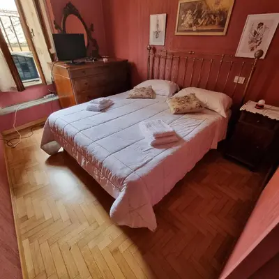 a bedroom with a large bed with a wooden floor at Casa Nicoletta in Rome