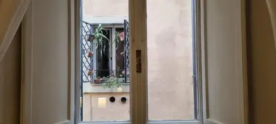 a glass door with a window with a plant at Zaira's House - Largo Argentina Campo de’ fiori in Rome