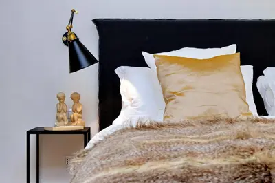a bedroom with a bed with a black headboard and a lamp at Luxury Charme between Pantheon and Spanish Steps in Rome