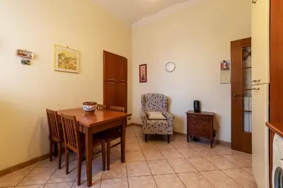 a dining room with a table and a chair at GuestHost - The secret garden of Rome! Apt x2 in Rome