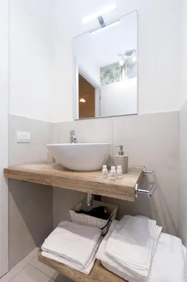 a bathroom with a sink and a mirror at Trastevere Andrea' s home in Rome