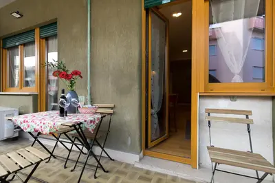 a table with a vase of flowers on a patio at Trastevere Andrea' s home in Rome