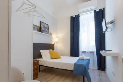 a small bedroom with a bed and a window at Hotel Cathrine in Rome