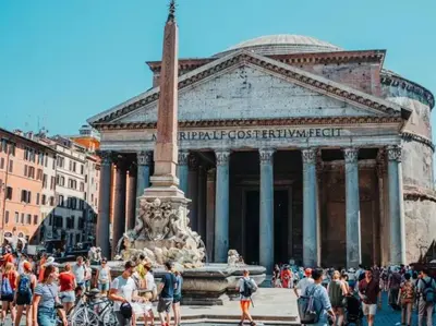 a group of people standing around a fountain in front of a building at Panoramic Flat Barberini in Rome