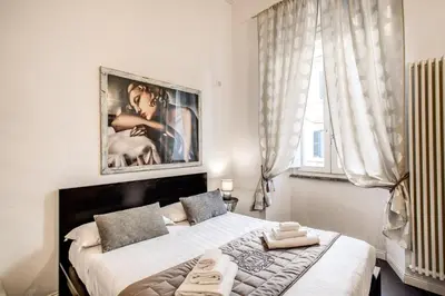 a bedroom with a large bed and a large window at Trastevere Miracle Suite in Rome