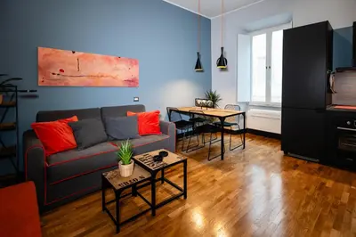 a living room with a couch and a table at Tolemaide Orange Apartment in Rome