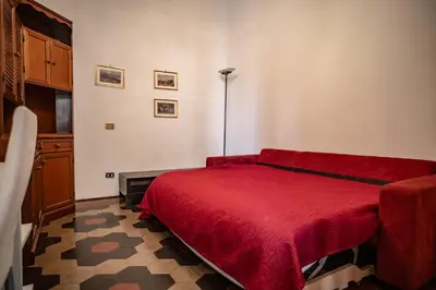 a bedroom with a red bed in a room at Domus Pretorio in Rome