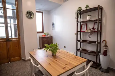 a dining room with a wooden table and a shelf at Domus Pretorio in Rome