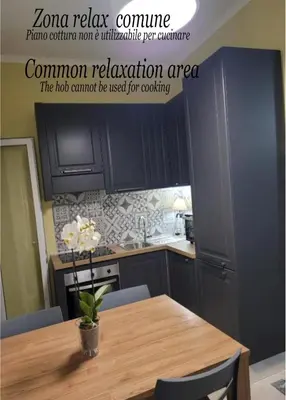 a kitchen with a table with a vase of flowers on it at Villa Bonelli Dreams in Rome in Rome