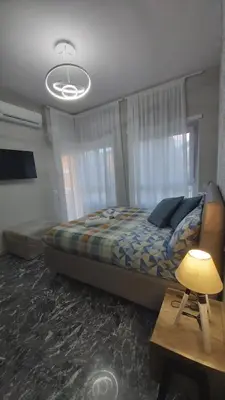 a bedroom with a bed and a table with a lamp at Villa Bonelli Dreams in Rome in Rome