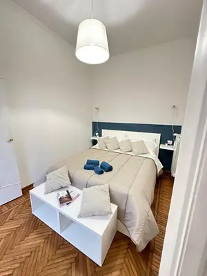 a large bed with white sheets and pillows at 1512 Apartment in Rome
