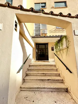 a set of stairs leading to a building with a door at 1512 Apartment in Rome