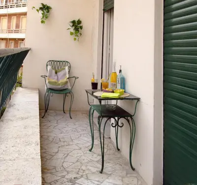 a table and a chair on a patio with drinks at 1512 Apartment in Rome