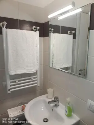 a bathroom with a sink and a mirror and towels at Jack's House - Tourist Rentals - in Rome