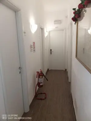 a hallway with a fire extinguisher on the floor at Jack's House - Tourist Rentals - in Rome