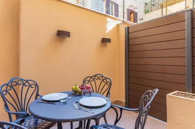 a blue table and chairs on a patio at MyItalyHome Roma in Rome