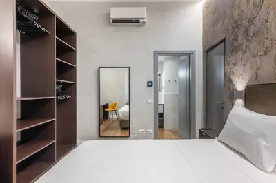 a bedroom with a large bed and a mirror at MyItalyHome Roma in Rome