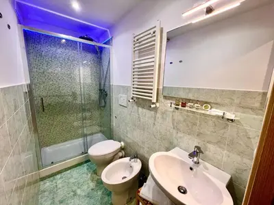 a bathroom with a sink and a toilet and a shower at Grande e storico appartamento ai Musei Vaticani in Rome