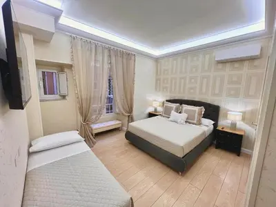 a bedroom with two beds and a window at Grande e storico appartamento ai Musei Vaticani in Rome