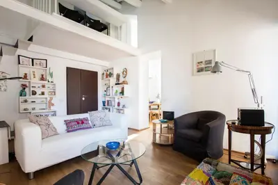 a living room with a white couch and a chair at Imperial Forums Apartment IN Campitelli in Rome