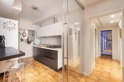 a kitchen with white cabinets and a stove top oven at Domus Rea - Vaticano - Metro Baldo degli Ubaldi in Rome