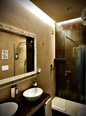 a bathroom with a sink and a glass shower at Trastevere House B&B in Rome