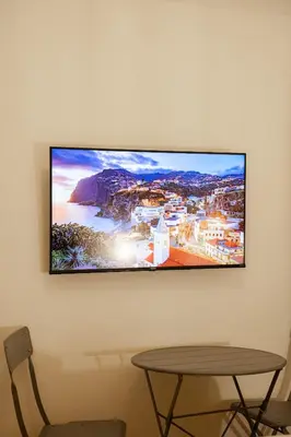a flat screen tv hanging on a wall at San Pietro Prestige Rooms in Rome