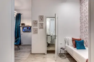 a living room with a couch and a mirror at Flaminio Royal Apartment in Rome