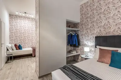 a bedroom with a bed and a wall with a mirror at Flaminio Royal Apartment in Rome