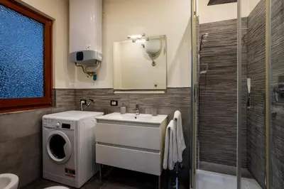 a bathroom with a sink and a washing machine at My Vatican Home in Rome in Rome