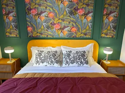 a bedroom with a large bed with two lamps at The Vatican Jungle loft con giardino vicino al Vaticano in Rome